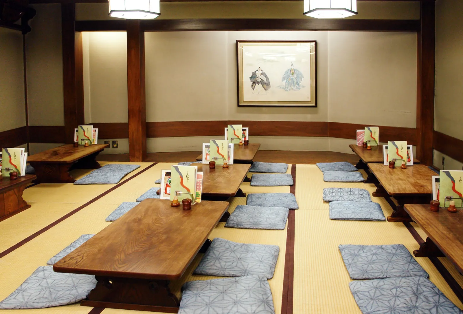 A tatami room in a Japanese ryokan arranged with low tables and cushions