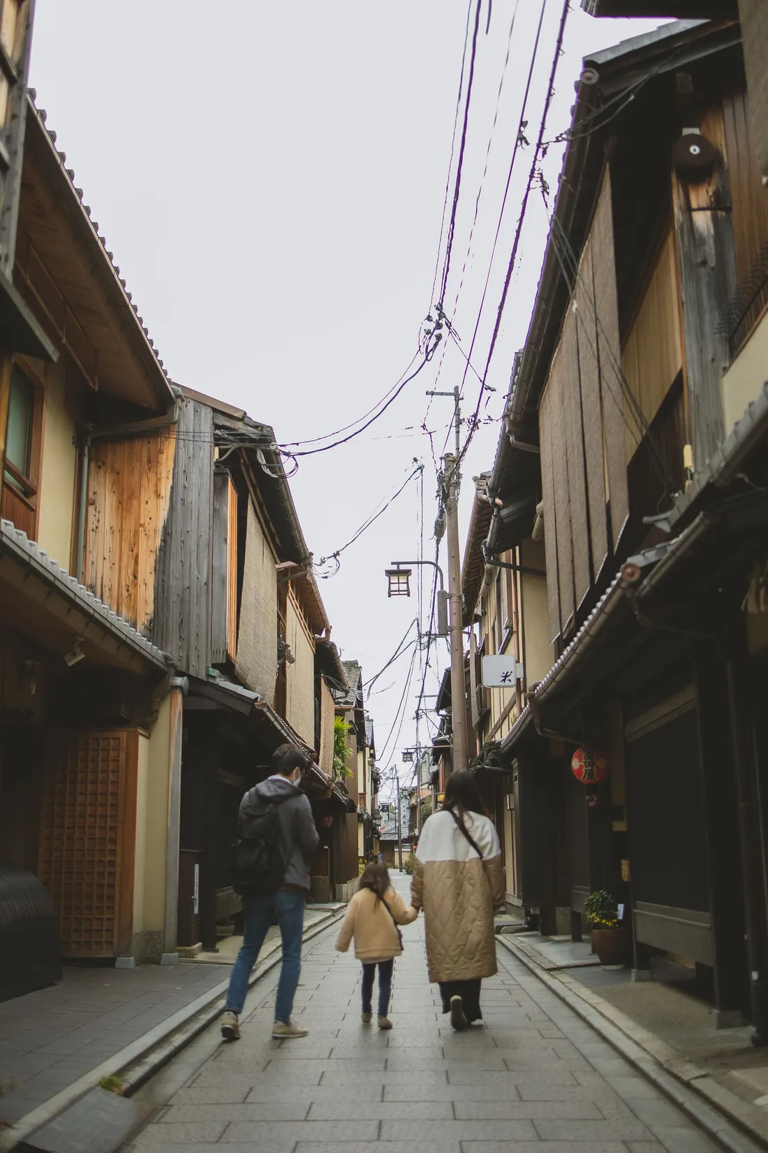 Family walking together through a traditional neighborhood in Kyoto, Japan
