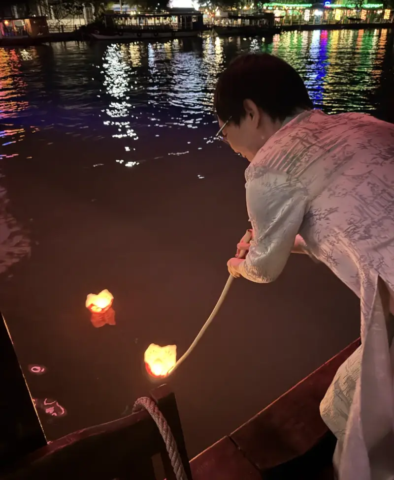 Jeremy floating lanterns in Hội An at night