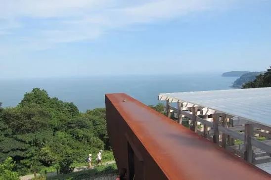 A rusted steel walkway at Enoura Observatory looking out over the sea