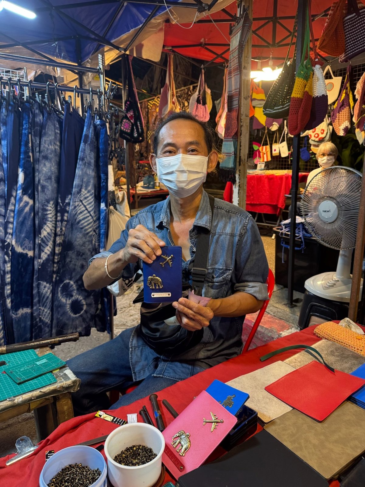 Man at a market booth in a traditional Thai village on the Mae Hong Son Loop