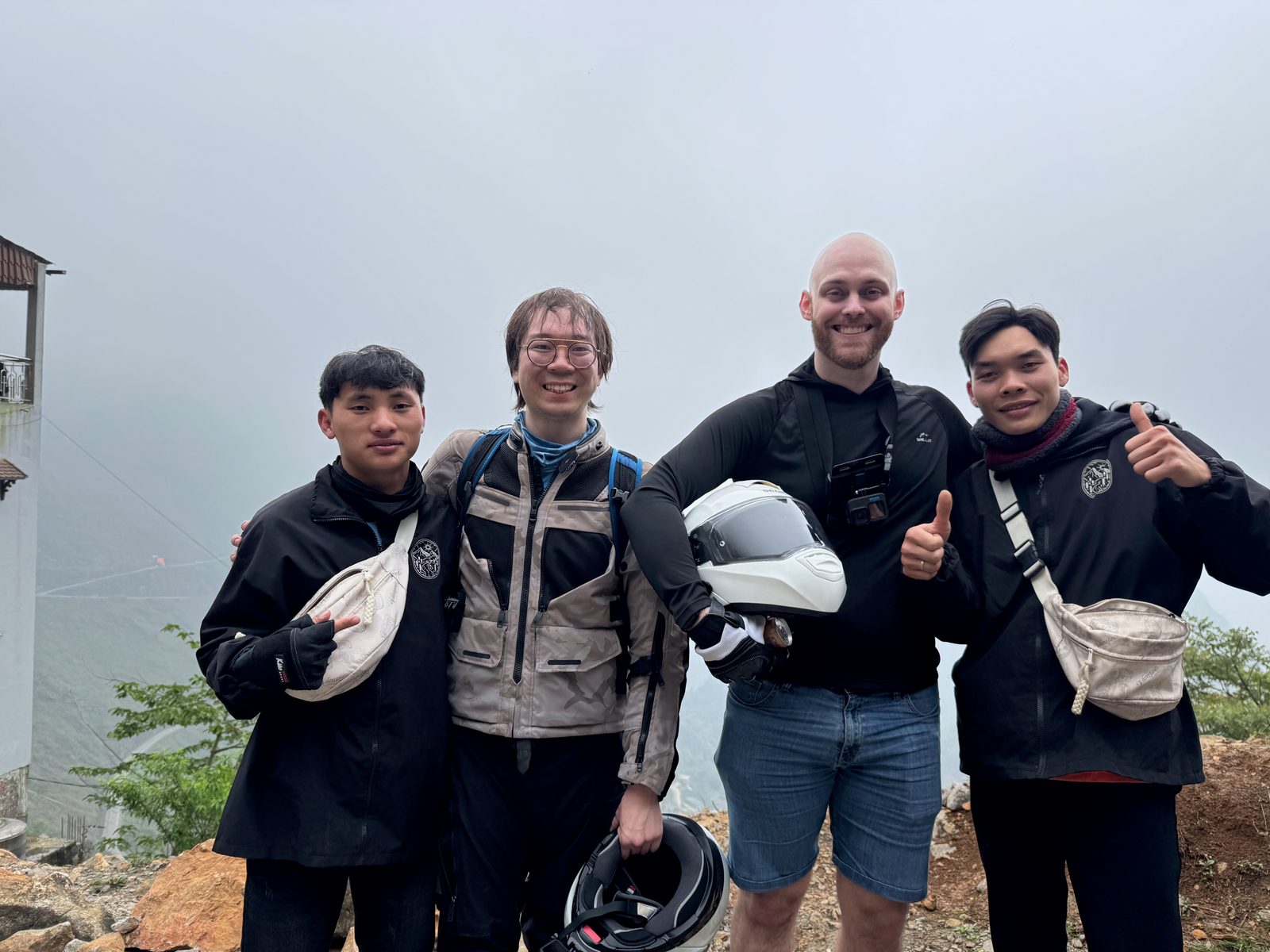 Three people at a mountain overlook, Đồng Văn