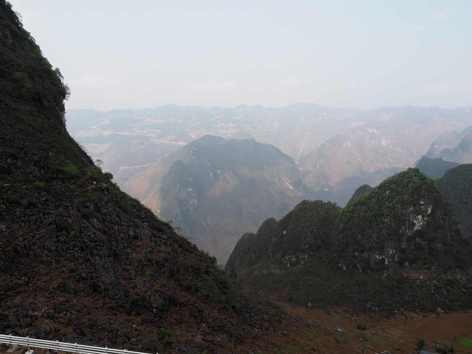 Rugged karst peaks and the road cutting through, Hà Giang Loop