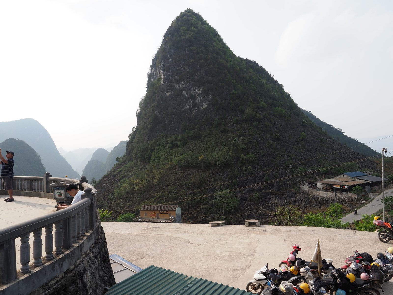Karst mountains above a small village, motos in the foreground