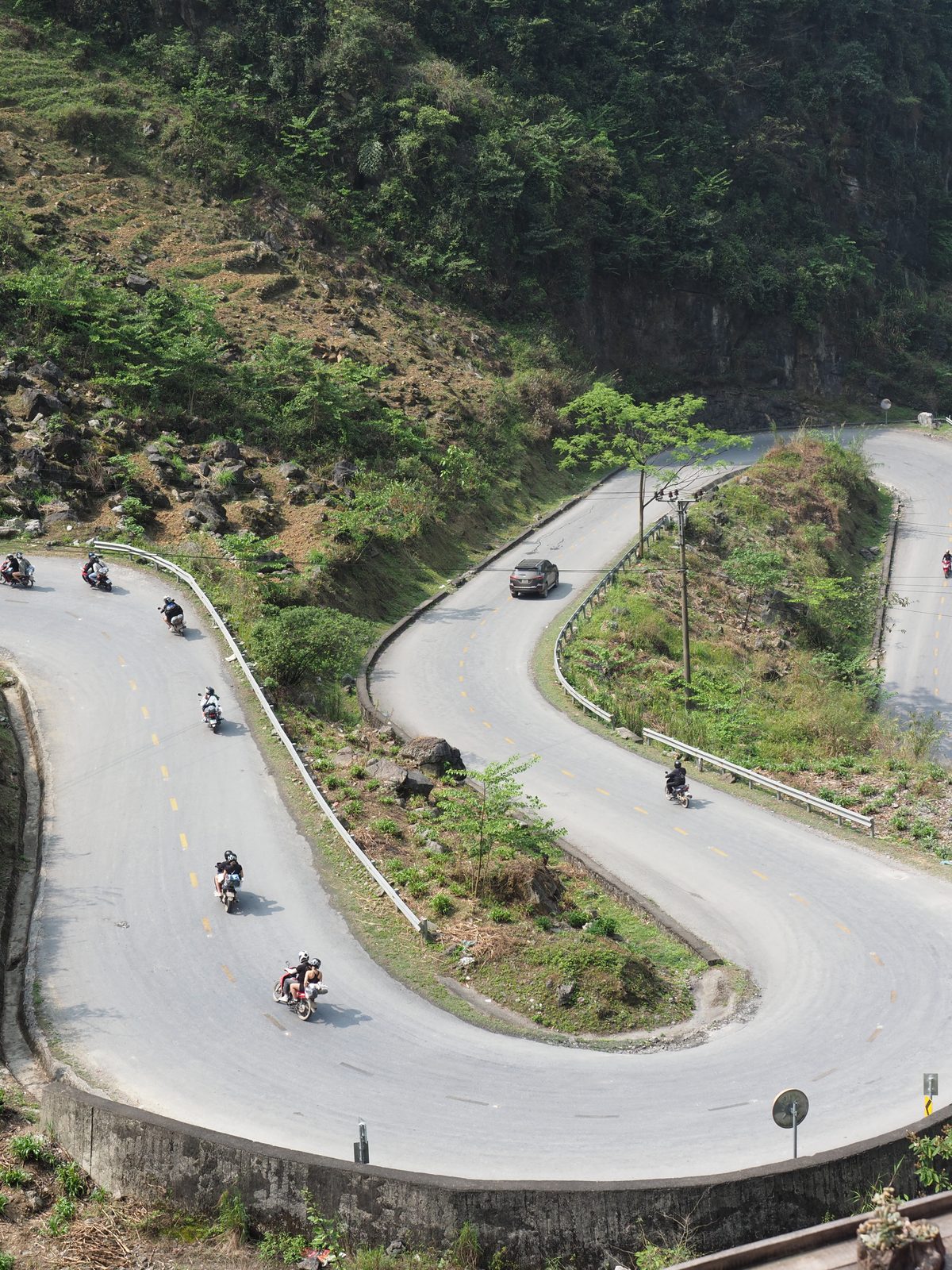 Motos lined up on a switchback, Hà Giang Loop