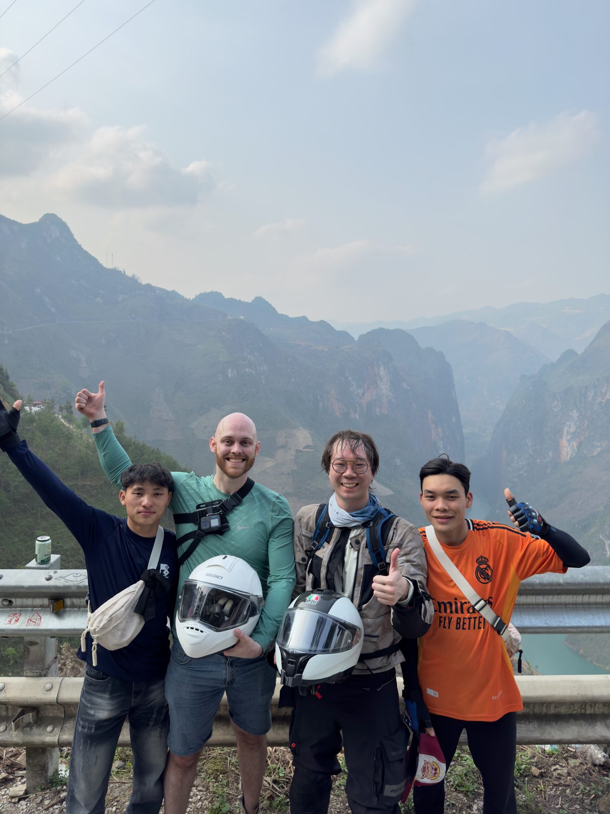 Group with motos at a hilltop overlook, Hà Giang Loop