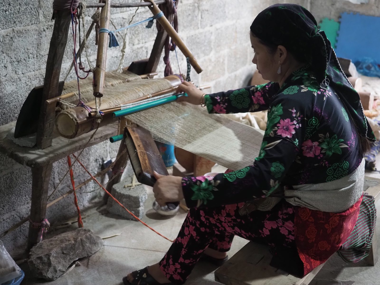 Woman weaving traditional textile in a Ha Giang village