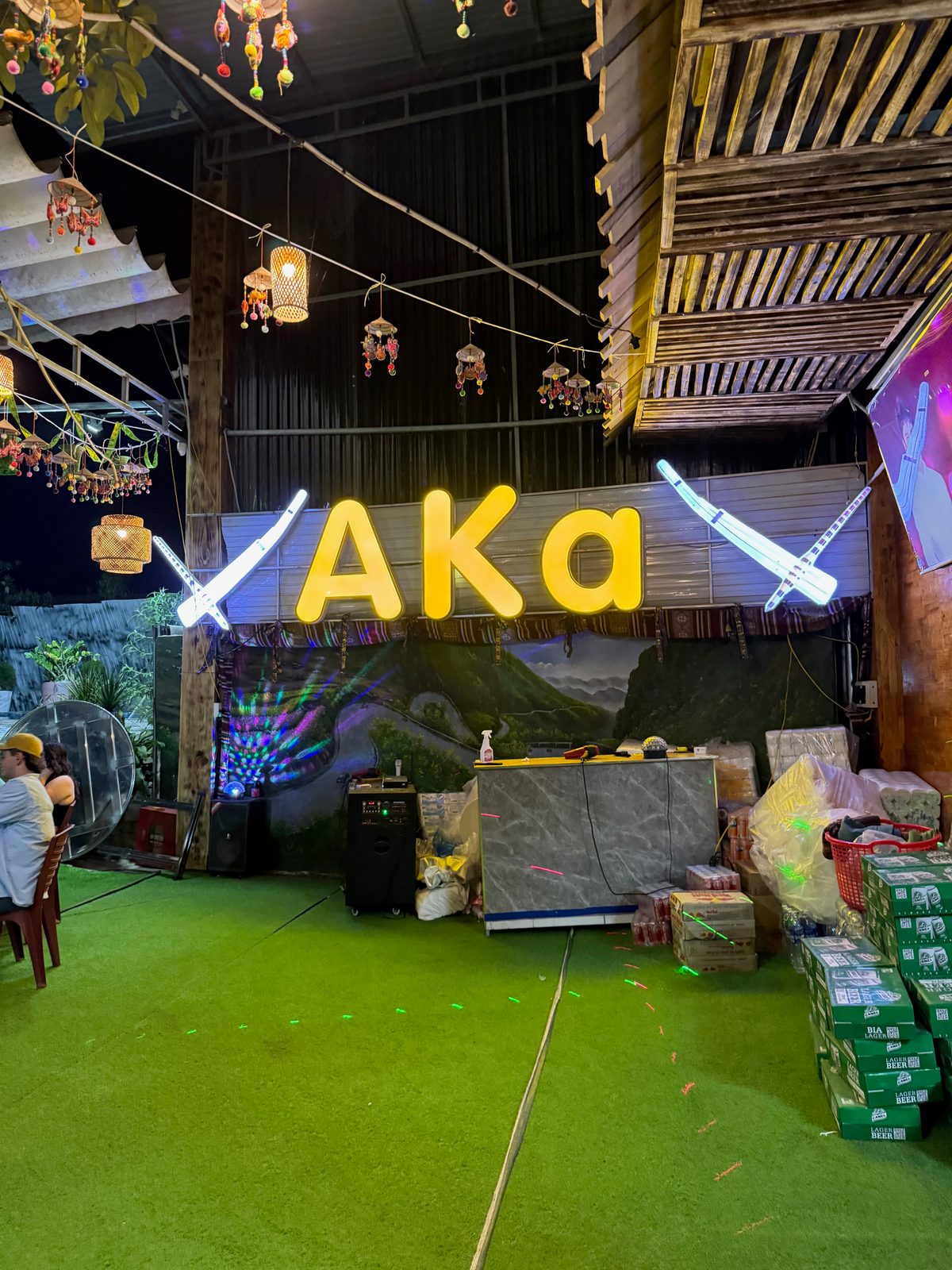 AKa bar at night — string lights and neon on the Ha Giang Loop